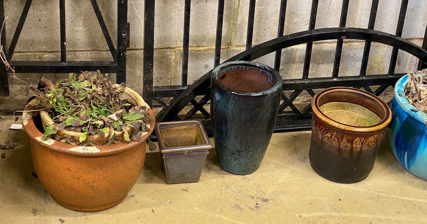 A collection of seven assorted composition and pottery garden planters, largest diameter 50cm, height 38cm